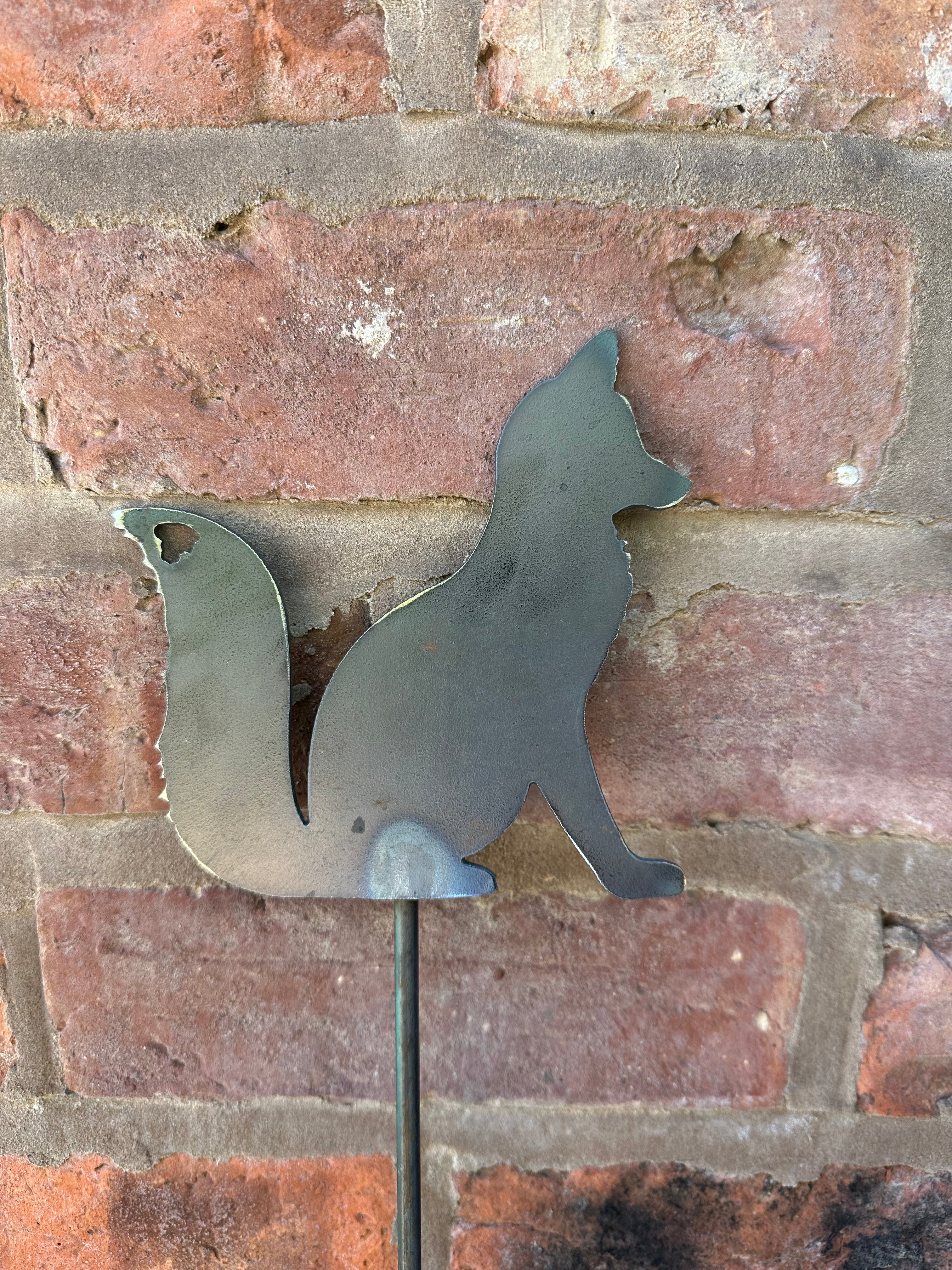 Metal Fox Sitting on a stake