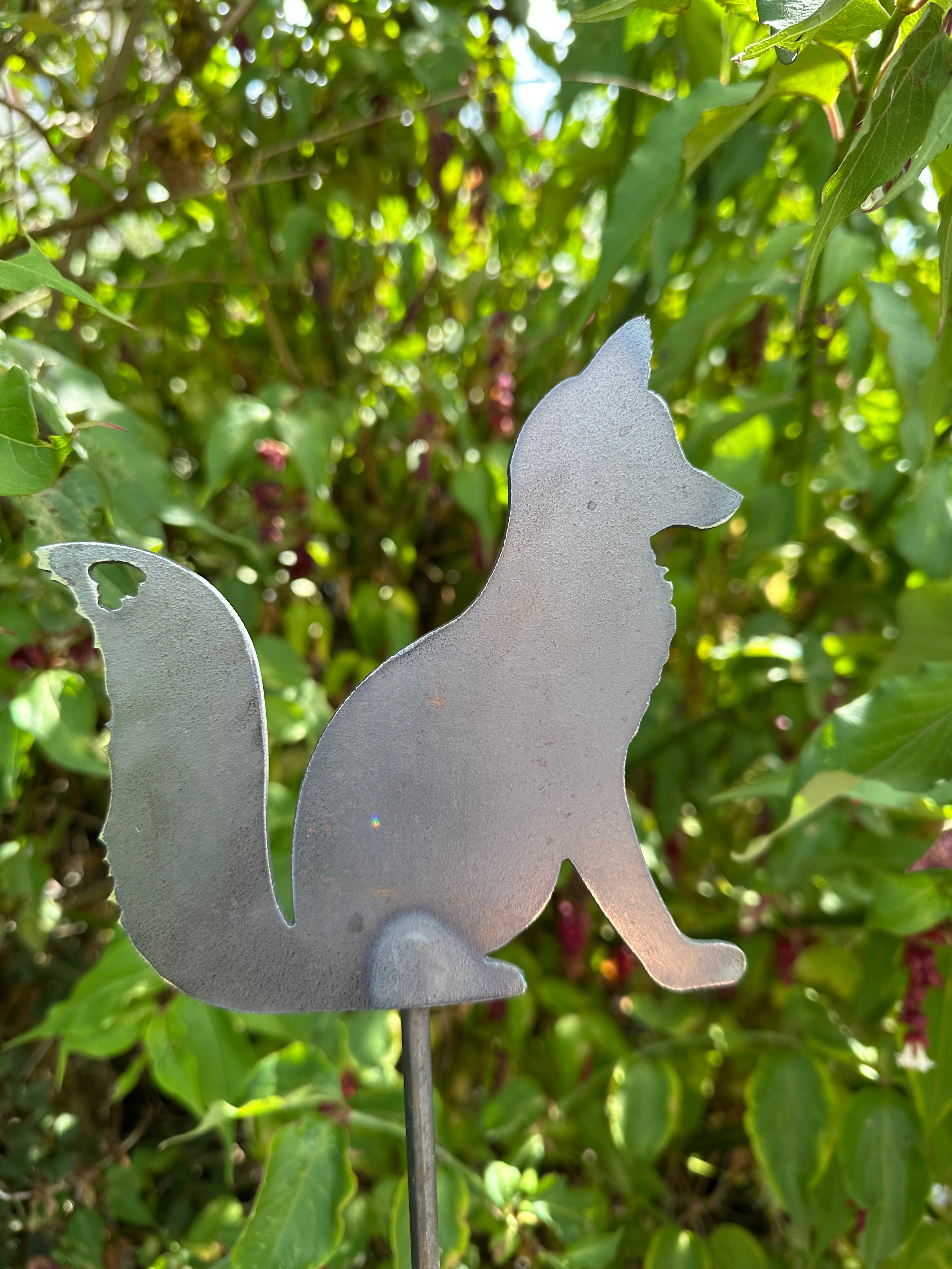 Metal Fox Sitting on a stake