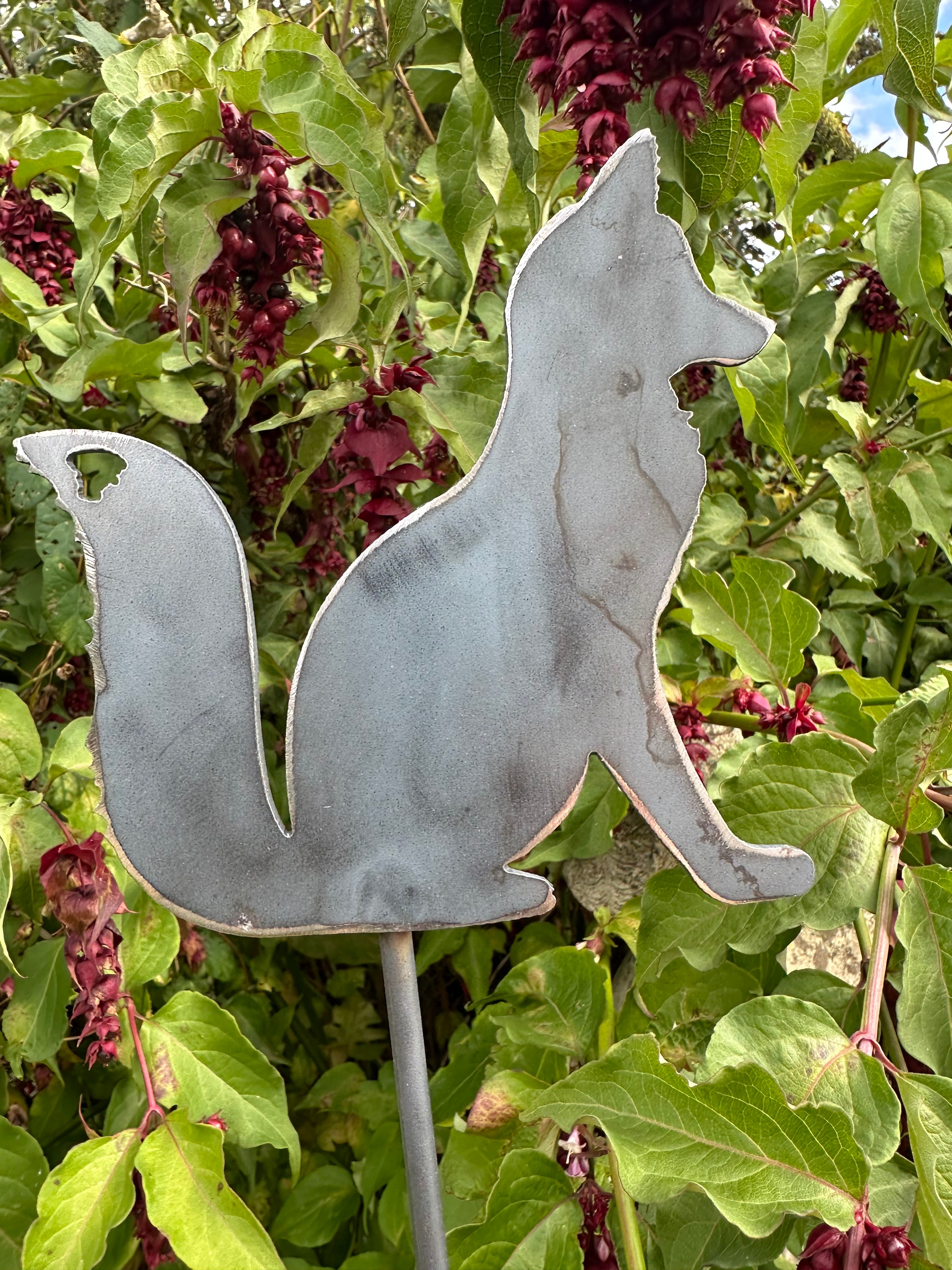 Metal Fox Sitting on a stake
